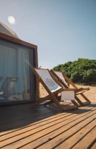 a lounger sitting on a deck on the beach at Domos Park in Mar de las Pampas