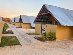 a row of houses with tin roofs at Riverside Lodge in Katima Mulilo