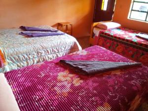巴納哈契的住宿－Hospedaje Santo Domingo，客房内的两张床和色彩缤纷的毯子