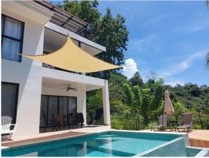 a villa with a swimming pool and a house at Sunset Villa - Upper Poolside in Sámara
