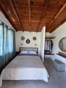 a bedroom with a bed and a wooden ceiling at Villa Filira in Achladies