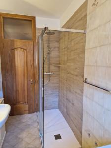 a shower with a glass door in a bathroom at La casa di Giò in Tirano