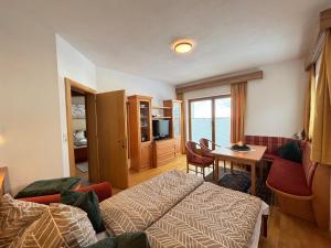 a hotel room with a bed and a table at MB Apartment in Ramsau im Zillertal