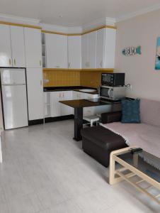 a kitchen with white cabinets and a table and a couch at Vera Natura Apartamento Paula in Vera
