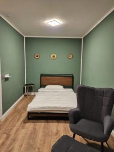 a bedroom with a bed and a chair at Sweet Home - 5 - in Duisburg
