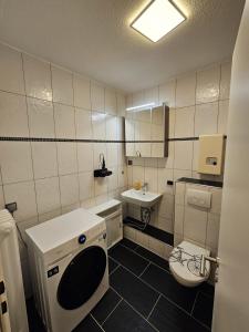a small bathroom with a toilet and a sink at Sweet Home - 5 - in Duisburg