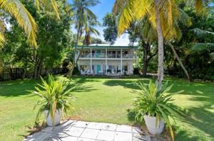 a house with two palm trees in front of it at LIttle Bay Lower in Islamorada