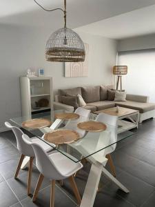 a living room with a glass table and chairs at Paraiso in Villaverde