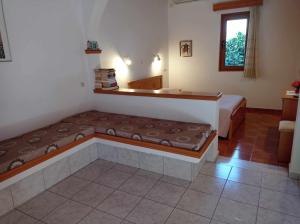 a bedroom with two beds and a window at Studios Ioanna Limnionas Samos in Ayía Kiriakí
