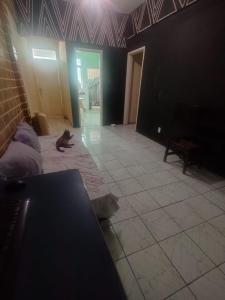 a cat laying on the floor in a room at Casa da Nanda in Fortaleza