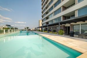a swimming pool on the roof of a building at Gorgeous Apartment in Asunción in Asuncion