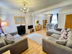 a living room with two couches and a fireplace at Portsmouth Urban Haven in Portsmouth