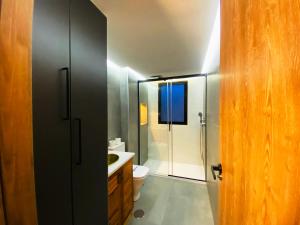 a bathroom with a toilet and a glass shower at Apartamentos Sierra Nevada BlueTTravel - Zona baja in Sierra Nevada +173 photos