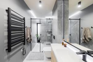 a bathroom with a shower and a toilet and a sink at Kalwa Lake House - dom nad jeziorem z prywatnym pomostem i jacuzzi oraz sprzętem wodnym in Pasym +41 photos