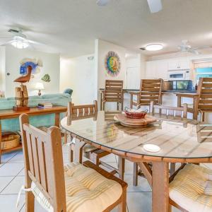 a dining room with a table and chairs and a kitchen at Little Bay Upper in Islamorada