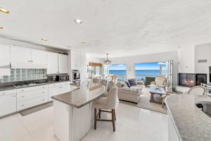 a kitchen and living room with a view of the ocean at Beachfront Malibu House with Sauna and Ocean-View Deck in Malibu