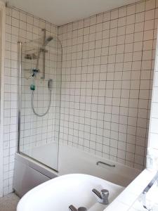 a bathroom with a shower and a toilet and a sink at Spacious 3 bedroom house in lovely location in Birmingham
