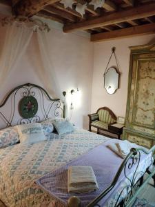 a bedroom with a large bed and a chair at BeB La Rosa Nel Verde in Lucca