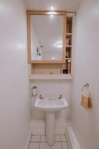 a bathroom with a sink and a mirror at Smithfield square Nest in Dublin