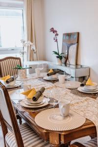 a dining room table with plates and wine glasses at Smithfield square Nest in Dublin