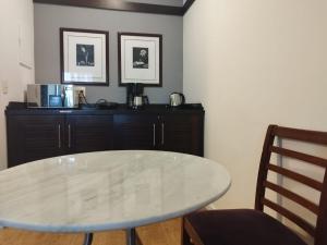 a dining room with a white table and a cabinet at QSA - Anora Spaces - Metropolis Alphaville in Barueri +83 photos