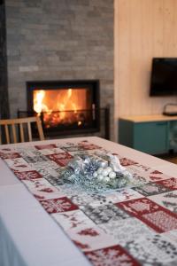 a table with a fireplace in a living room at U Hanky pod Hrbkom in Repište