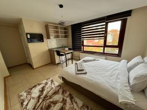 a bedroom with a large bed and a kitchen at BROWN in Ankara