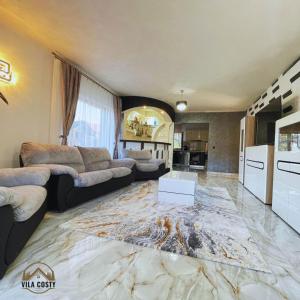 a large living room with a marble floor at Vila Costi in Campina