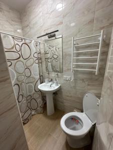 a bathroom with a toilet and a sink at Modern Apartments Uzhgorod in Uzhhorod