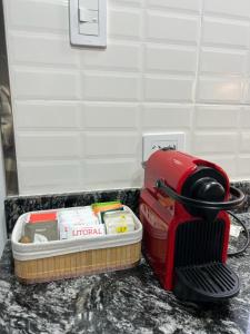 a red toaster sitting on top of a counter at Departamento en San Lorenzo in San Lorenzo