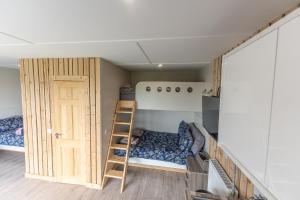 a small room with a bunk bed and a ladder at Sheriffs Mountain Lodge in Derry Londonderry