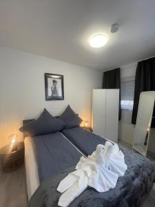 a bedroom with a bed with towels on it at City Apartment am Rhein Bonn in Bonn