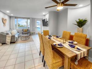 a dining room and living room with a table and chairs at Oceanfront Condo with Front Patio, Gas Grill, Fire Pit - Prime Location!! in San Diego