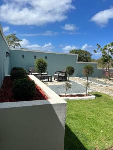 a garden with a bench and a building at Playa y Campo Apartment #2 in Isabela