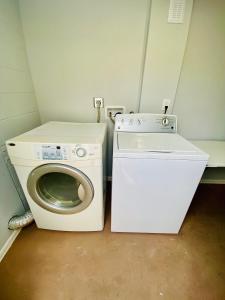 a washing machine and a washer in a small room at Gorgeous suite central location in St Petersburg