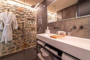 a bathroom with a sink and a mirror at Boutique Via Roma 33 -Tuscany Experience - Hotel & Spa in Stia