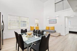 a living room with a table and chairs and a couch at Ocean Drive Apartment Suites in Miami Beach in Miami Beach