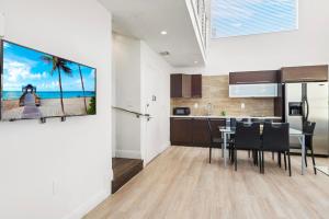 a kitchen and dining room with a view of the beach at Ocean Drive Apartment Suites in Miami Beach in Miami Beach