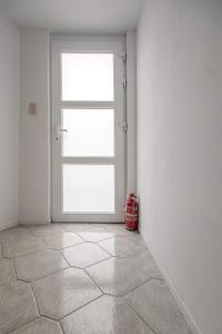 une pièce vide avec une grande porte dans l'angle dans l'établissement Appartement 2 chambres, à Liège
