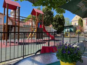 a patio table with a playground with a playgroundintendent at Hotel Lipa in Bojnice