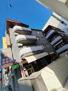 a tall building with signs on the side of it at Bed and Breakfast Majesty in Niš