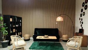 a living room with a black couch and a table at MoryńApartments ROOMS in Moryń +27 photos