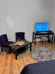 a living room with a coffee table and a laptop at Chatelain 2 in Brussels