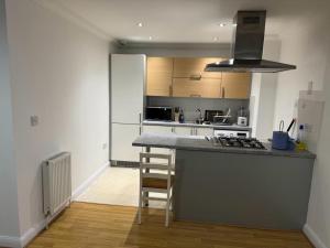 a kitchen with a counter and a stove top oven at LUXURY APARTMENTS in Dagenham