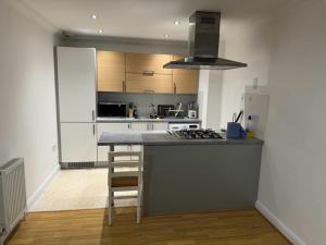 a kitchen with a counter and a stove top oven at LUXURY APARTMENTS in Dagenham