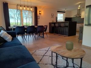 a living room with a blue couch and a table at Maison des Fées d'Achouffe in Houffalize