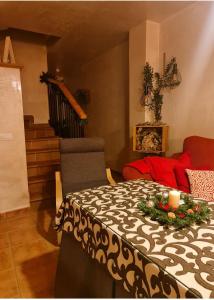 a room with a table with a black and white blanket at Entre Vistas in Zahara de la Sierra