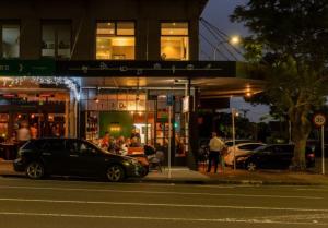 a car parked in front of a gas station at night at Herne Bay 1 Bedroom Apartment - Stay Auckland in Auckland