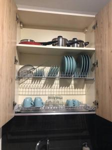 a kitchen shelf with dishes and utensils on it at Appartamento in zona centrale a uso esclusivo in Bari