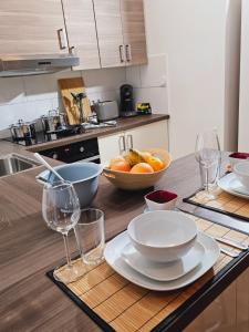 a kitchen with a table with plates and wine glasses at Modern Studio near Düsseldorf Airport & Messe/Fair in Meerbusch